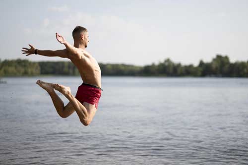 man-jumping-into-water